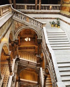 an aerial view of the inside of a building with stone stairs and wooden balconies