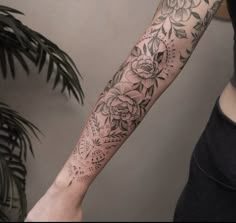 a woman's arm with flowers on it