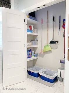 the inside of a white closet filled with cleaning supplies