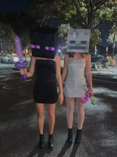 two women dressed up as minecrafts walking down the street at night with purple flowers in their hands