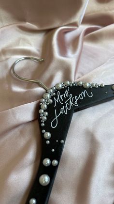 a wedding dress hanger with pearls and the word mr and mrs written on it