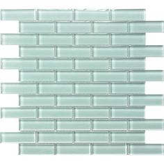 the back side of a glass tile backsplash that is light green and white