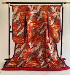 "Gorgeous red silk gold brocade in vintage wedding KIMONO UCHIKAKE JUNI-HITOE imperial style. JUNI-HITOE has been worn at special occasions such as weddings, royal ceremonies or imperial noble events since the HEIAN period and it means twelve layers originally. This JUNI-HITOE was made into modern style and is a single layer of kimono with three layers color trims with lining. Rare type of top quality textile with full of Japanese motifs in multi color. Crane, SAKURA cherry blossom, Chrysanthemu Traditional Red Kimono For Tea Ceremony, Traditional Red Silk Kimono, Traditional Gold Kimono For Wedding, Traditional Red Kimono For Wedding, Traditional Gold Ceremonial Kimono, Kabuki Costume, Kimono Art, Japanese Motifs, Red Kimono