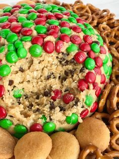 a cake covered in cereal and candy surrounded by pretzels