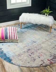 a round rug with a bench on top of it in front of a black wall