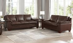 a living room filled with brown furniture and windows