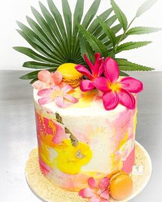 a colorful cake with flowers and leaves on top