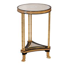 a gold and black side table with glass top