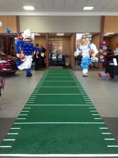 an artificial football field is decorated with balloons