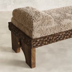 a bench made out of wood and sheep fur