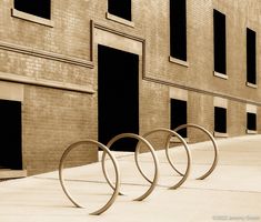 three circular metal objects sitting in front of a building