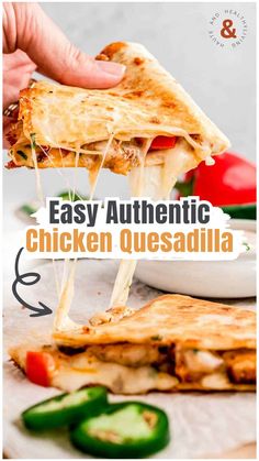 a hand holding a slice of chicken quesadilla over a white plate with green peppers