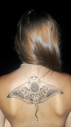 a woman with a tattoo on her back