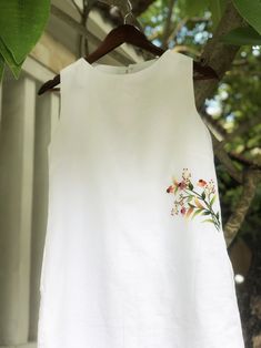 ❤ The white linen hand embroidered dress is very soft, skin friendly, breezy and comfortable.  ❤ Item description: - A lovely dress with embroidered wild flowers motifs. - Material: linen, button, embroidery threads. - Environmentally friendly. - This dress is very useful, go with any outfit, that can be used to go out, go shopping...    It is a perfect gift for yourself or your beloved.  ❤ Care instructions:      The best way to wash embroidery cloth is to put it in soapy water (with a mild detergent and cold water at 86 ºF/30oС) for 20 minutes. Try to not wash the item with other clothing that might cause damage, such as zippers, buttons or different colors. You wash it by hand, and if you have dirty patches on your garment, you can gently rub them, it's best not to rub directly against Embroidered Linen Dress For Vacation, White Embroidered Linen Beach Dress, White Linen Floral Print Dress, White Linen Dress With Floral Print, White Embroidered A-line Summer Dress, White Embroidered Floral Dress For Summer, White Embroidered A-line Dress For Summer, White A-line Embroidered Summer Dress, White A-line Embroidered Dress For Summer