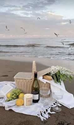 a picnic on the beach with food and wine