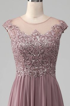 a dress with sequins on the shoulders and neckline is shown in front of a mannequin