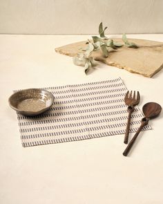 a table with utensils and a bowl on it