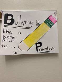 a bulletin board hanging on the wall with a drawing of a pencil sticking out of it