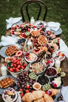 a wooden table topped with lots of food