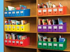 the shelves are filled with books and folders for children's library storage,