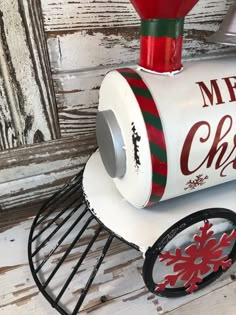 a white and red christmas candy dispenser on a rack with snowflakes