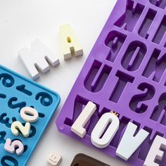 letters and numbers made out of ice cubes sitting next to each other on a table