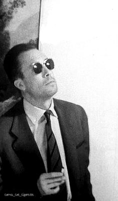 a man in a suit and tie wearing sunglasses