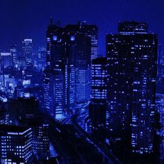 the city is lit up at night with blue lights