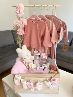 a baby's gift basket with clothes and toys