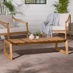 two chairs and a coffee table on a patio