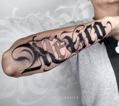 a man with a tattoo on his arm that says,'strength'in cursive writing