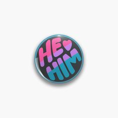 a button with the words he's him in pink, blue and purple on it