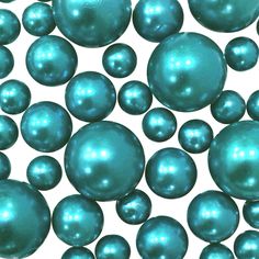 many blue pearls are scattered together on a white surface