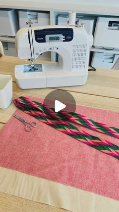 a video demonstrating how to use a sewing machine on a piece of pink and green fabric