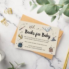 a card with the words books for baby on it next to some plants and candles