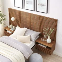 a bed with two vases on each side and a wooden slatted headboard