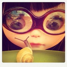 a close up of a child's face wearing goggles with a snail on it