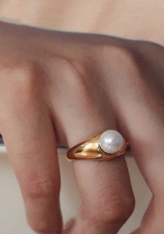 This perfect everyday gold ring features a single dainty round shell pearl. The ring is designed with a curved band. A minimalist style with a vintage feel.It complements any outfit perfectly by itself or by stacking with any statement rings, or with any other width band rings.Works well as both a men's and women's wedding band, as well as a promise ring or engagement ring, entirely unisex design.# T A GGold Pearl Ring, Pearl Statement Ring, Gold Band Ring with Pearl, Gold Stacking Ring, Stackable Ring, Thick Ring, Thin Ring, Narrow Ring, Couple Ring, Couple Band, Gold Band for him, Gold Band for Couples, Gold Stacking Ring for him, Statement Rings, Different Size Band Rings Pearl Rings In Gold For Women, Pearl Rings For Men, Elegant Handmade Gold Pearl Ring, Gold Minimalist Pearl Ring, Minimalist 14k Gold Pearl Ring, Adjustable Gold Pearl Ring, Classic Adjustable Gold Pearl Ring, Pearl Ring Vintage, Pearl Gold Ring