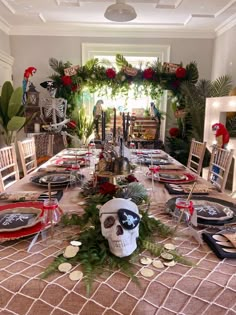 a table set for halloween dinner with skulls and wreaths