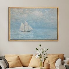 a painting hanging on the wall above a couch