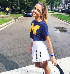 a young woman is walking down the street