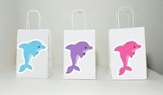 three small bags with dolphins on them