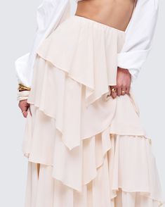 5 layers of drama 😌 Twirl into perfection in this cream maxi skirt made from crepe georgette fabric complete with an asymmetrical waistline, tiered ruffles, and an elastic waistband 🤍 Long Layered Skirt, Cream Maxi Skirt, Long Ruffle Skirt, Ruffle Maxi Skirt, Georgette Fabric, White Jersey, Ruffle Shorts, Layered Skirt, Mini Wrap Dress