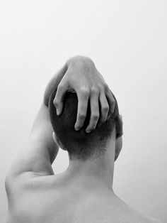 a man with his hands on the back of his head