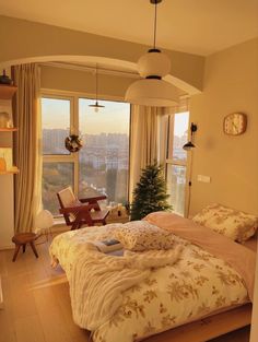 a bedroom with a large window overlooking the city