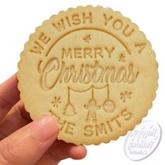 a cookie with the words merry christmas and we wish you a merry christmas on it