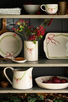 christmas decorations and dishes are displayed on shelves