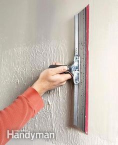 a woman is using a magnetic marker on the wall