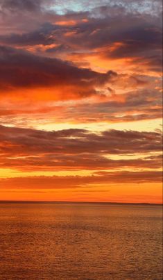 an orange and blue sunset over the ocean