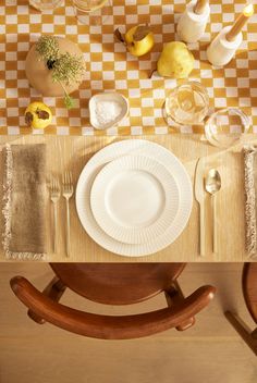 an overhead view of a dining table with plates and utensils on the table